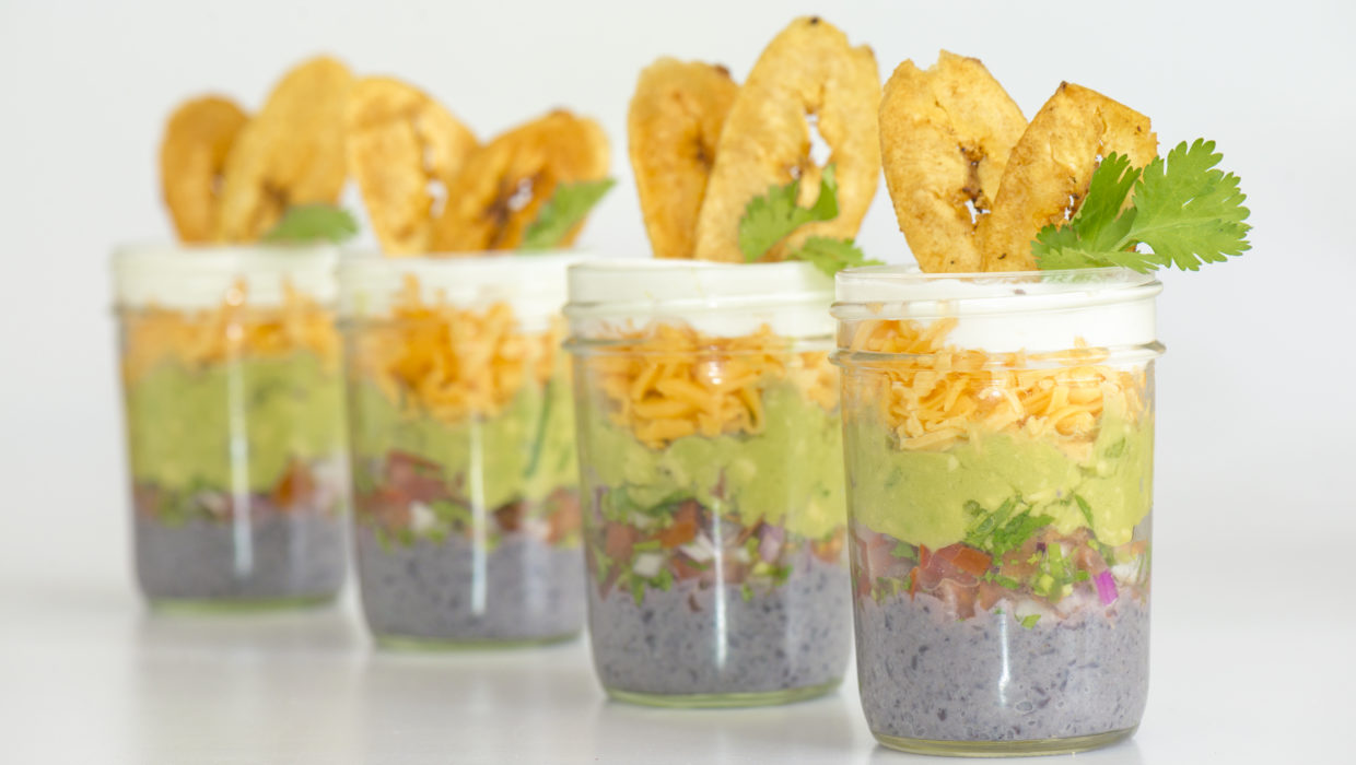 Five layer dip in mason jars, plantain chips