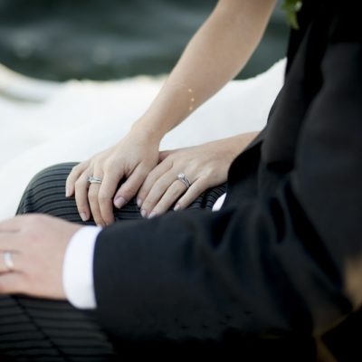 Bride and groom show off wedding rings
