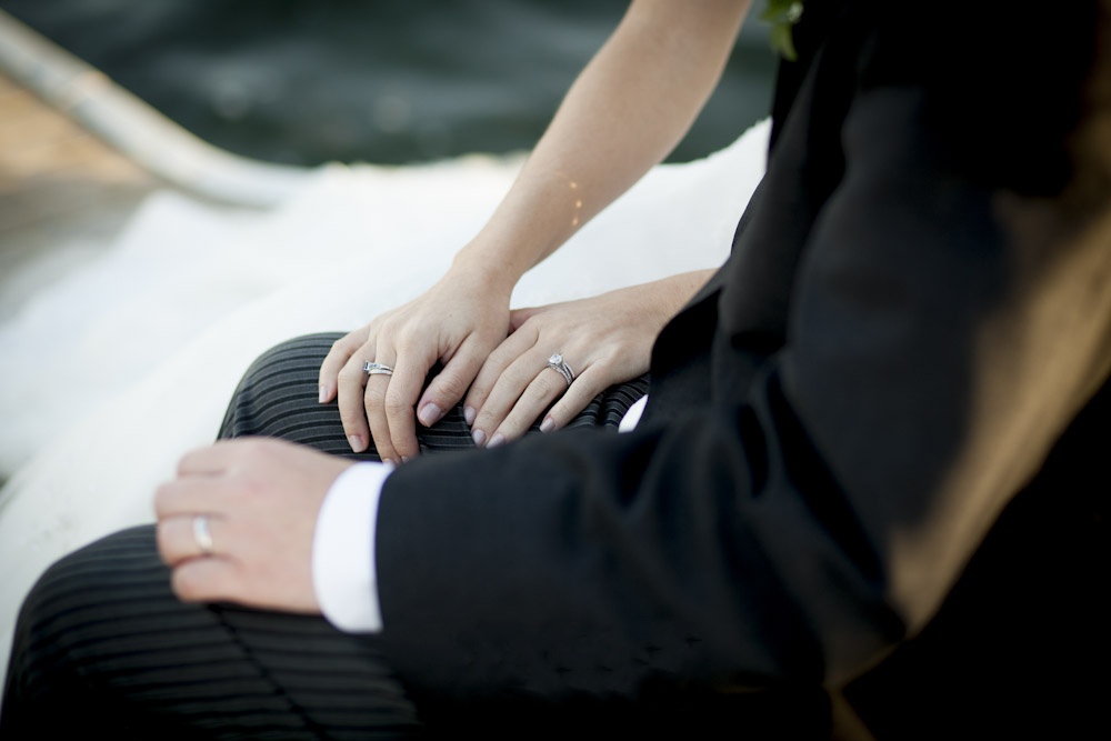 Bride and groom show off wedding rings