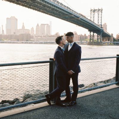 Mr. and Mr. under the bridge on their wedding day