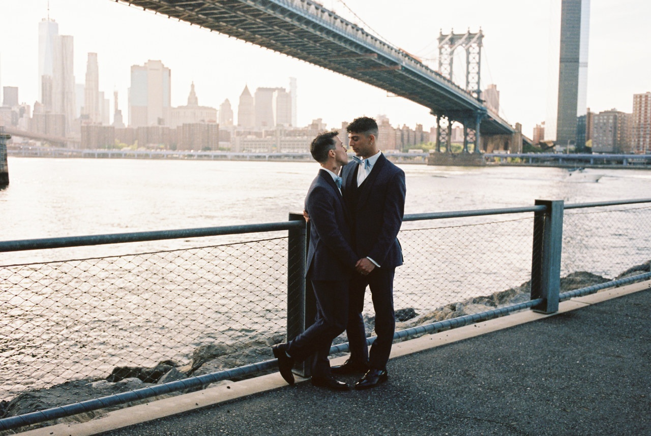 Mr. and Mr. under the bridge on their wedding day